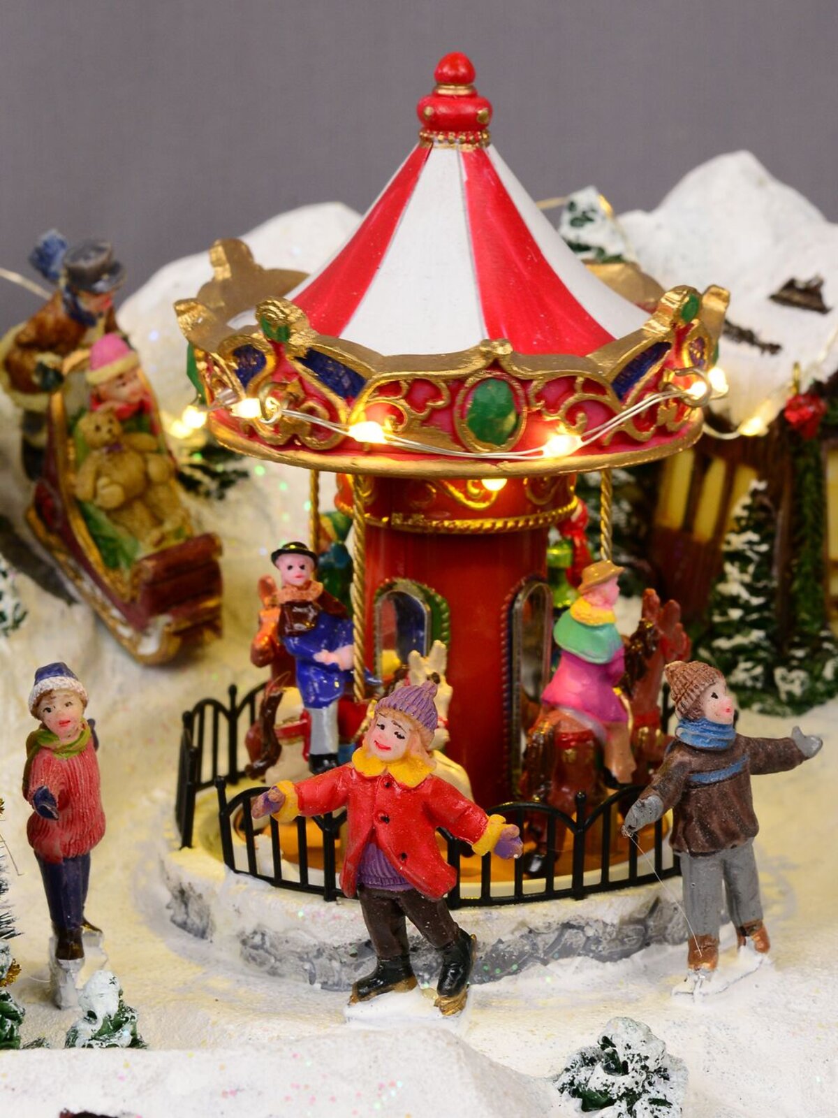 Northern Winter Christmas Village Scene With Rotating Train & Carousel - 26cm — image 6