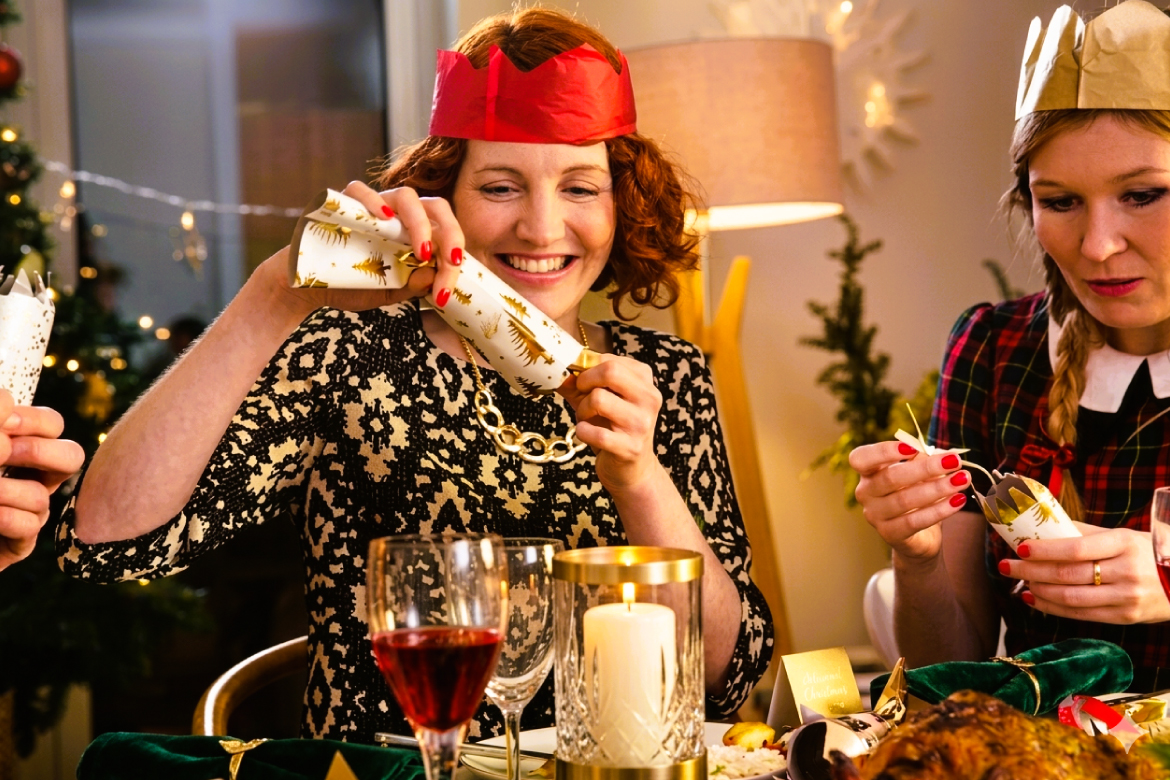 Opening Bon Bons Around Festive Christmas Table